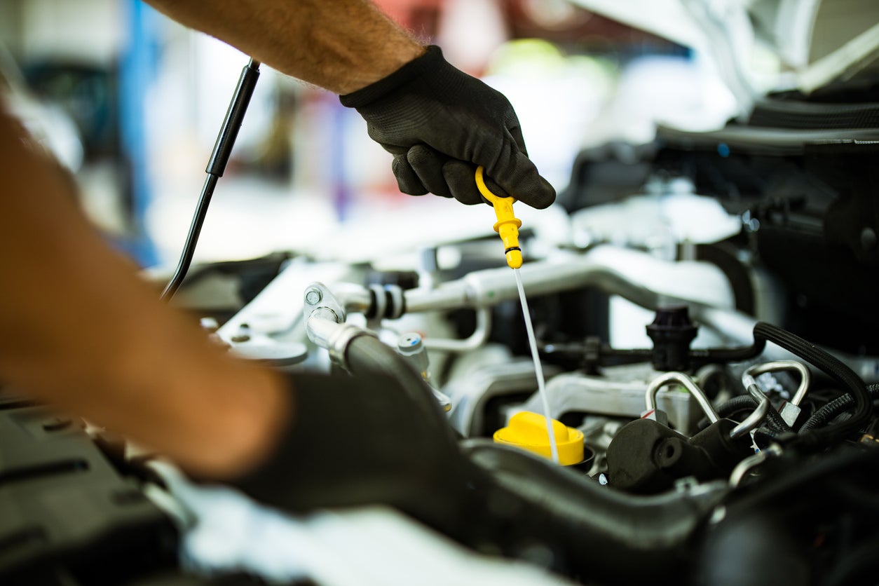 Image of someone checking the oil in a vehicle